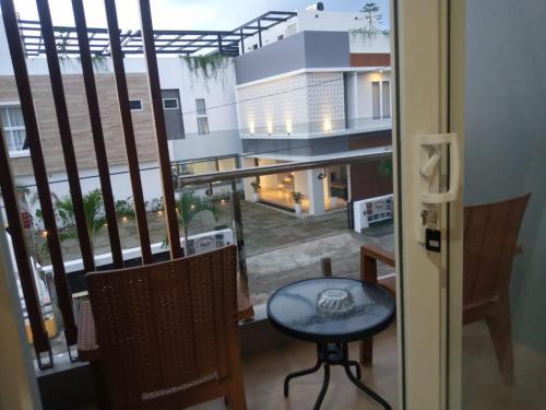 a view of a balcony with a table and chairs at PURNAMA BALIGE HOTEL in Balige