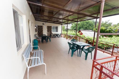 a patio with tables and chairs on a balcony at Casa Selena in Costinesti