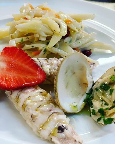 a white plate of food with pasta and a strawberry at Hotel Tetto delle Marche - Ristorante dei Conti in Cingoli