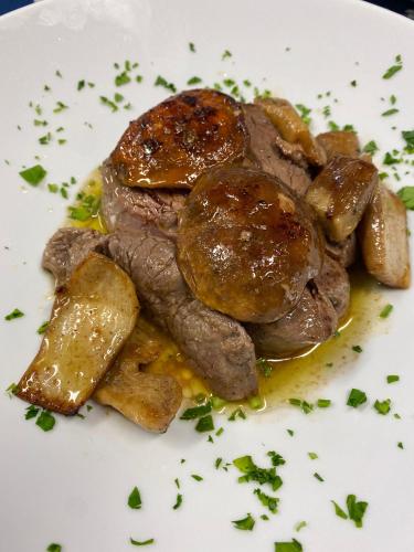 a plate of food with meat and potatoes on it at Hotel Tetto delle Marche - Ristorante dei Conti in Cingoli