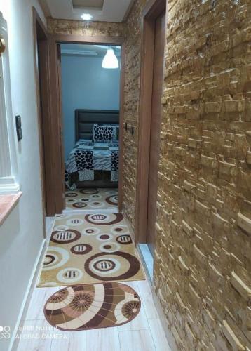 a hallway with a tile floor and a brick wall at مشروع أشقار in Tangier
