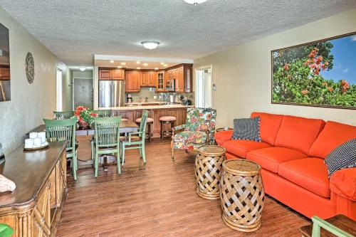 a living room with a red couch and a kitchen at Elysian Resort Condo with 3 Balconies and Amenities! in St Thomas