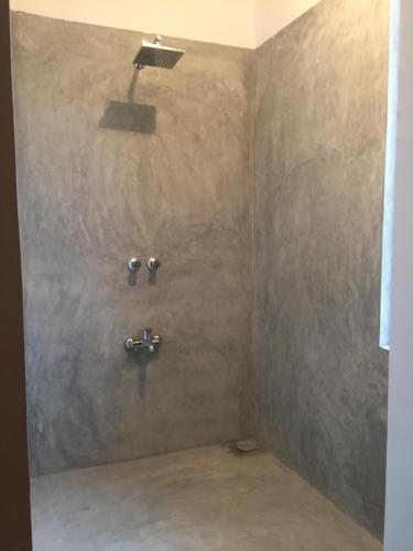 a bathroom with a shower with two faucets at Lali Villa & Fruit Garden in Galle