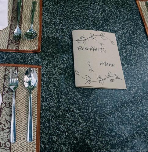 a table with a sign that says breakfast menu on it at Natural Relax Villa in Siem Reap