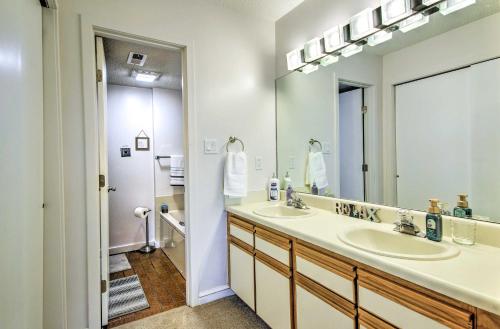 a bathroom with two sinks and a large mirror at Lake of the Ozarks Vacation Rental with Grill! in Lake Ozark