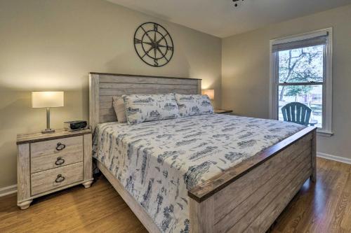 a bedroom with a bed and a clock on the wall at Oak Island Vacation Rental Less Than 1 Mi to Beach! in Oak Island
