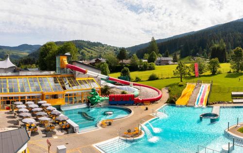 a resort with a water park with a water slide at The Little Pool House in Wagrain