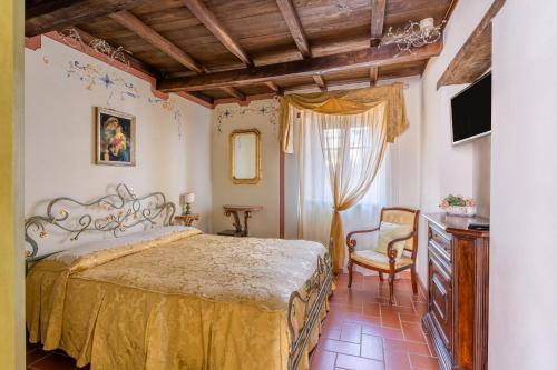 a bedroom with a large bed and a chair at Melograni 4 in Molazzana