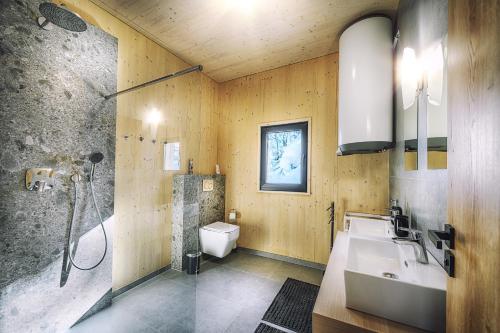 a bathroom with a shower and a sink and a toilet at Chata pod žlabom in Liptovský Mikuláš