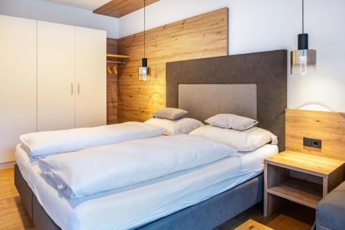 a bedroom with two beds and a table at Falsers Mountain Lodge in Cornedo all'Isarco