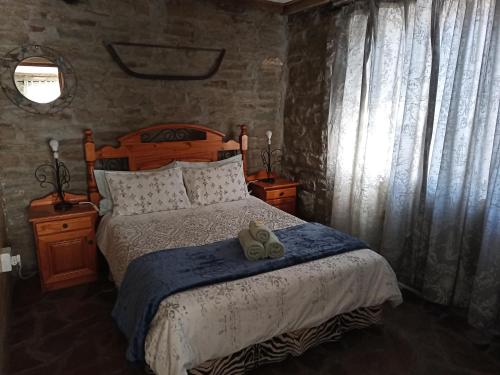 a bedroom with a bed with two teddy bears on it at Die Stal in Sutherland