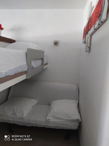 a small room with two bunk beds in it at Studio superdevoluy in Le Dévoluy