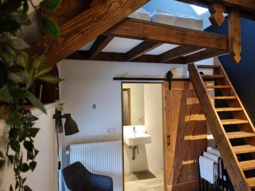 a bathroom with a staircase and a sink at B&B Barvaux, Durbuy in Durbuy