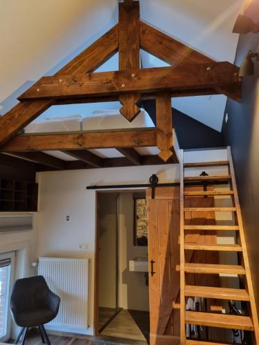 a loft conversion of a house with wooden beams at B&B Barvaux, Durbuy in Durbuy