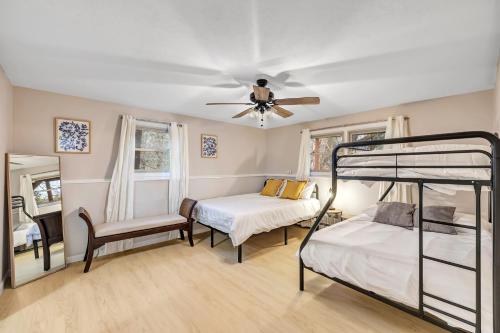 a bedroom with two bunk beds and a ceiling fan at Hazelwood Haven near Lambeau! Duplex in Green Bay