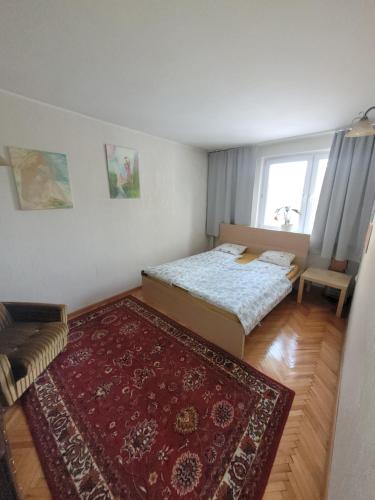 a small bedroom with two beds and a rug at MY SUITE 60th in Gdańsk