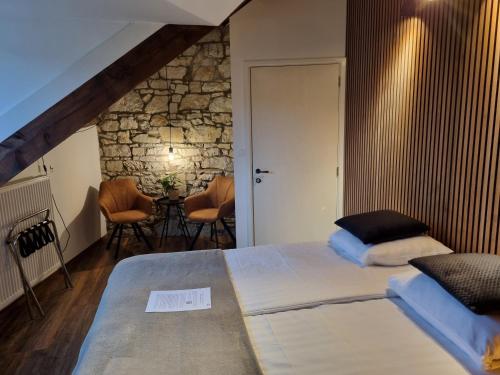 a bedroom with a bed and a table with chairs at B&B Barvaux, Durbuy in Durbuy