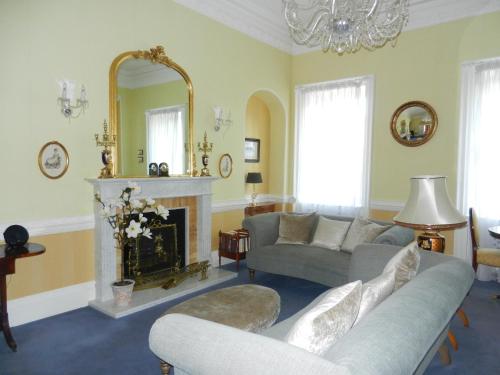 a living room with a couch and a fireplace at The Circus Apartment in Bath