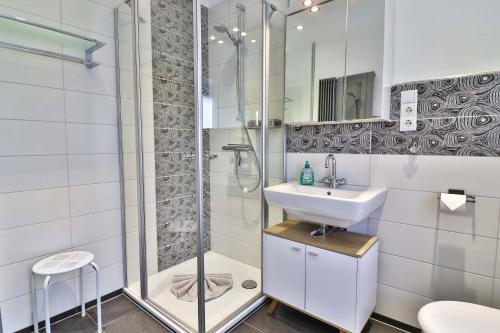 uma casa de banho com um chuveiro e um lavatório. em Kiek rin bi Kati - Ferienwohnung 1 em Langeoog