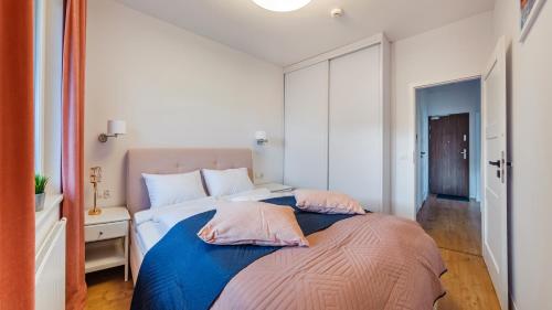 a bedroom with a bed with two pillows on it at Nexo, Sun & Snow in Puck