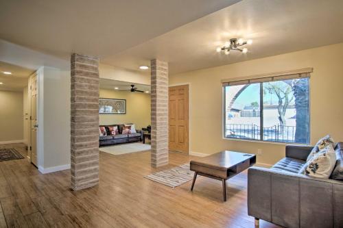 a living room with a couch and a table at Eastside Home with Pool Near Hiking! in Tucson