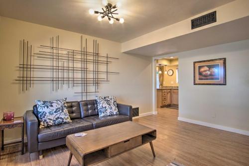 a living room with a couch and a table at Eastside Home with Pool Near Hiking! in Tucson