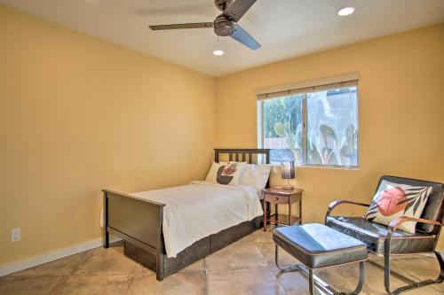 a bedroom with a bed and a chair and a window at Eastside Home with Pool Near Hiking! in Tucson