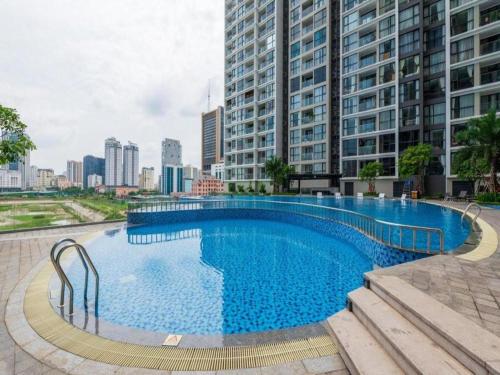 a large swimming pool in a city with tall buildings at Vinhomes Sky Lake Phạm Hùng View Keangnam in Hanoi