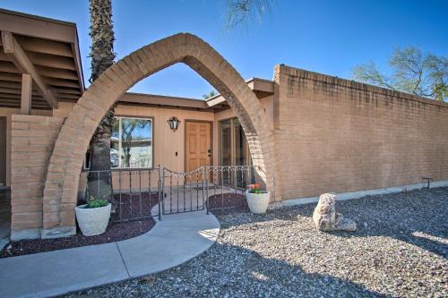 a home with an archway in front of a house at Eastside Home with Pool Near Hiking! in Tucson