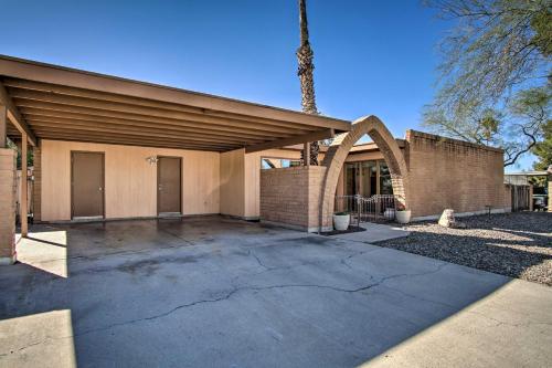 a brick building with a driveway in front of it at Eastside Home with Pool Near Hiking! in Tucson