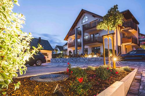 a house with a car parked in front of it at Pflugwirts Hotel und Gasthaus in Oberkirch