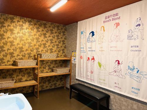 a bathroom with a shower curtain and a sink at Asama Onsen FAN! MATSUMOTO in Matsumoto