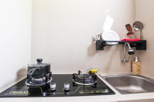 a kitchen counter with a coffee pot on a stove at The Polumb Garden Bedugul in Tabanan