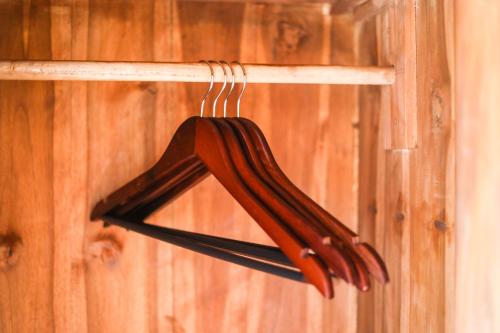a brown umbrella hanging on a wooden wall at The Polumb Garden Bedugul in Tabanan