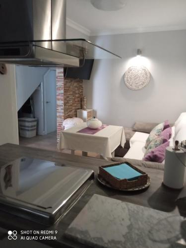 a living room with a couch and a kitchen at Apartamento Solis in Chipiona