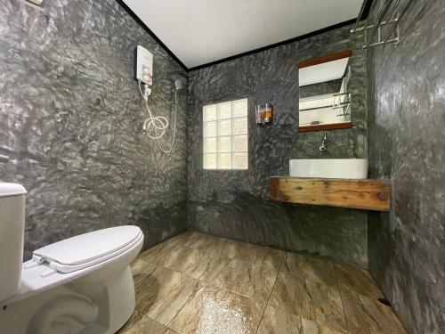 a bathroom with a toilet and a sink at Mangrove bungalow & restaurant in Ko Kood
