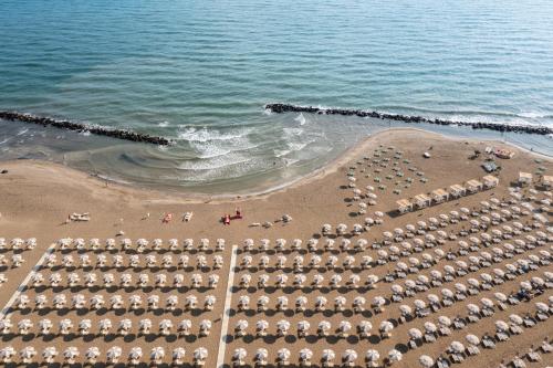 an aerial view of a beach with umbrellas at Rimini Family Village in Rimini