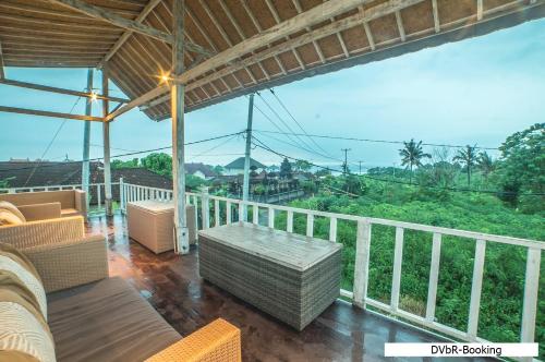 a balcony with a view of the mountains at Dayung Villas By Reccoma in Nusa Lembongan