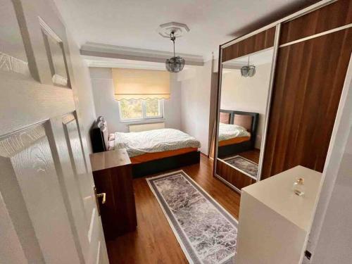 a small bedroom with a bed and a mirror at 2 bedroom 5 bed peaceful calm full kitchen,all items available Luxury And relax in Istanbul