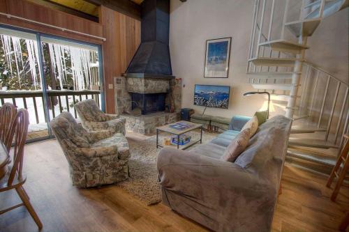 a living room with a couch and a fireplace at Spiral Staircase home in Kings Beach