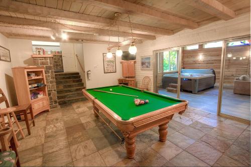 a living room with a pool table and a bedroom at Cheyenne Chalet home in Round Hill