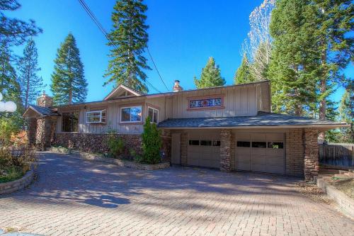 a house with a car garage in front of it at Cheyenne Chalet home in Round Hill