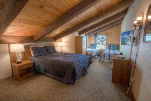 a bedroom with a bed in a room with wooden ceilings at Tahoe Olympic condo in Stateline