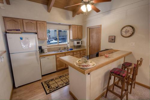 a kitchen with a white refrigerator and a counter at Whispering Wood home in Incline Village