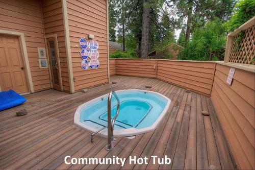 a hot tub on a deck with a house at Delightful McCloud condo in Incline Village