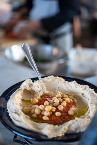 a bowl of food with beans and a spoon in it at Akotika boutique in ‘Akko