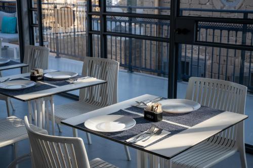 a table and chairs with plates and silverware on it at Akotika boutique in ‘Akko