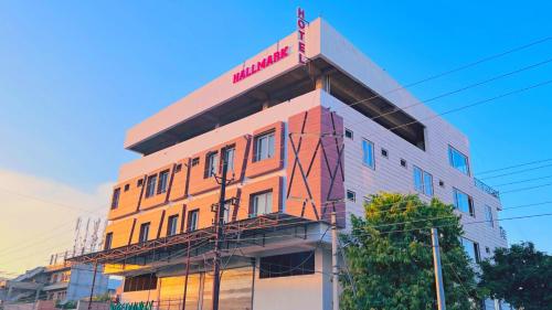 a building with a sign on the top of it at Hotel Hallmark By THC Group in Kota