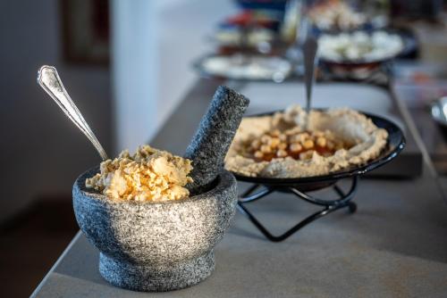 two bowls of food are sitting on a table at Akotika boutique in ‘Akko