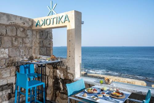 a restaurant with a table and chairs and the ocean at Akotika boutique in ‘Akko